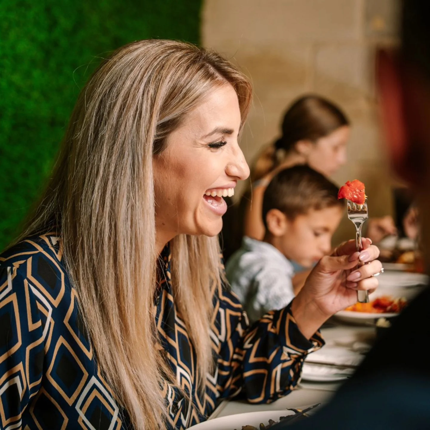 A guest enjoying a meal at Vineleaves