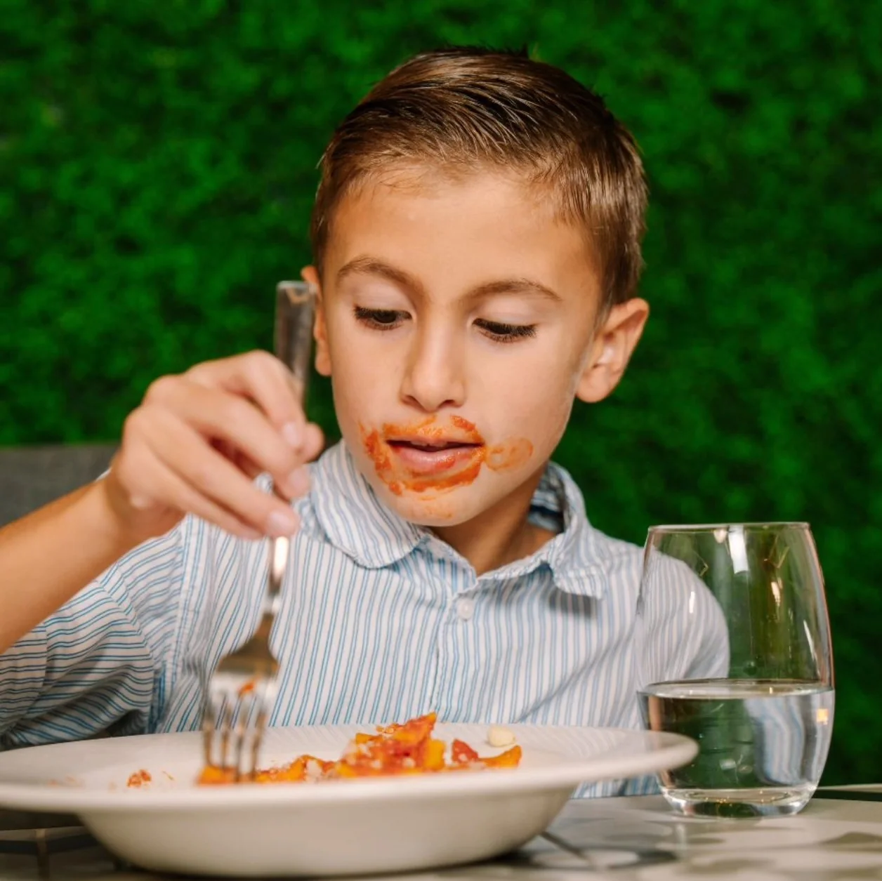 A young guest enjoying pasta at Vineleaves